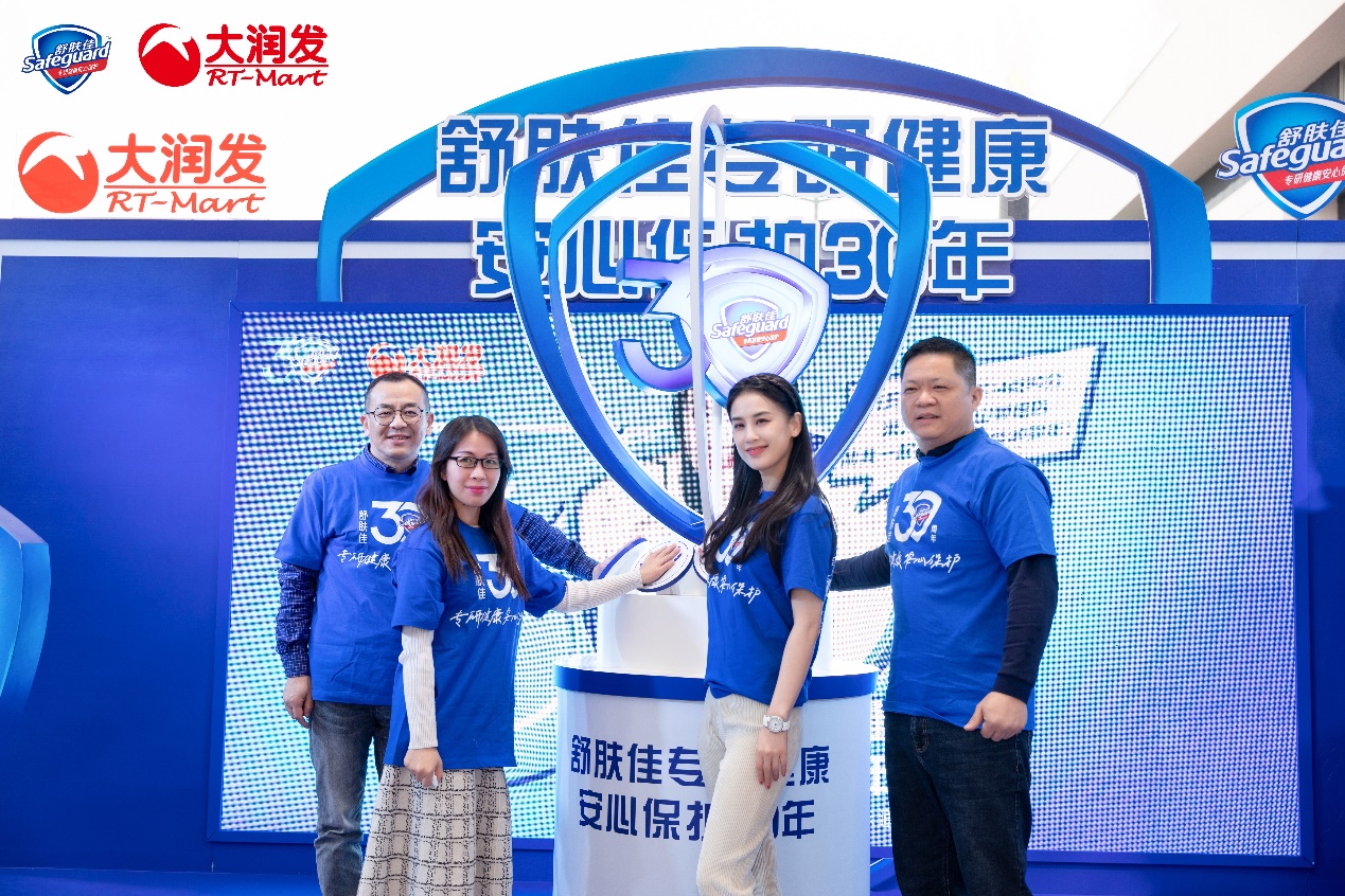 A group of people posing for a photo in front of a basketball hoop

Description automatically generated